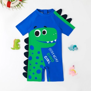Blue one-piece kids swimsuit with green dinosaur print and 3D fin details