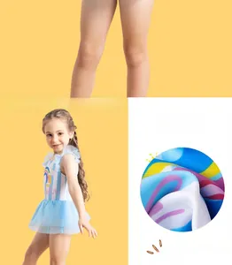 Detail view of girls rainbow striped swimsuit showing blue tulle skirt and print