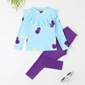 Two-piece girls long sleeve swimsuit with light blue cherry print top and purple pants