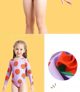 Detail view of the tomato print on children's purple long sleeve swimsuit fabric