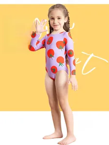 Detail of girls long sleeve one-piece swimsuit with red tomato print on lavender fabric