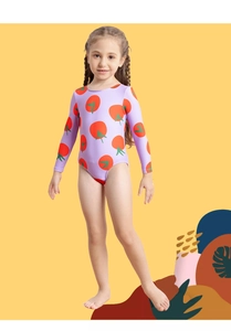 Detail of girls long sleeve swimsuit featuring vibrant tomato prints on light purple fabric
