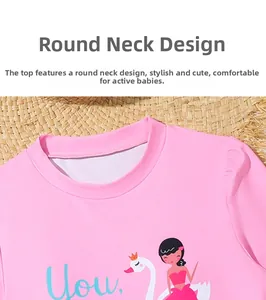 Detailed view of kids pink swim top with swan print and comfortable round neckline