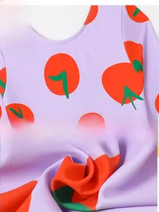 Detail of round neckline and red tomato prints on purple quick-dry kids swimwear