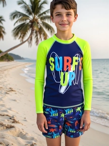 Boy's long-sleeve swimwear detail with surf print at sunset beach backdrop