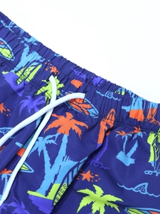 Close-up of boys' quick-dry swim trunks featuring tropical prints and elastic drawstring waist