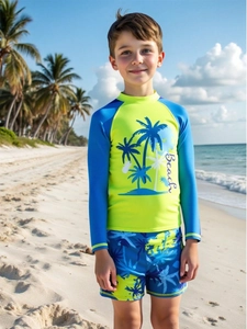 Detailed view of kids sun protection swimwear set with tropical coconut tree print