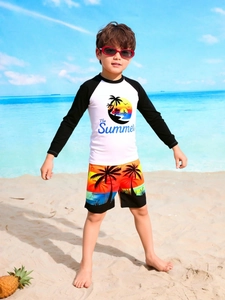 Detail of boys long-sleeve sun protection swimwear with beach sunset and palm tree print