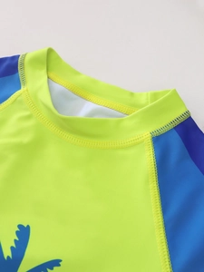 Detailed close-up of crew neck and durable flatlock seams on boys rash guard swimwear