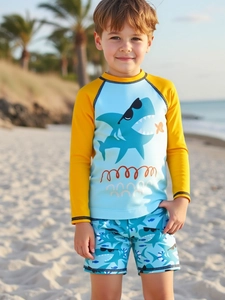Boy's two-piece swimsuit set with cartoon shark print on beach with palm trees