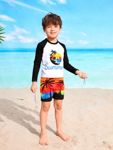 Detail of boys' long sleeve swim top and tropical sunset print shorts for beach sports