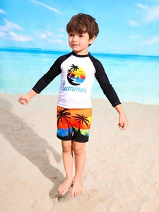 Detail of boys' long sleeve rash guard set with tropical sunset print and palm trees