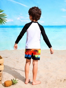 Detail of boys' long-sleeved sun protection swimwear with tropical coconut tree print