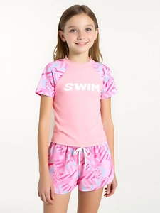 Detail of girls' two-piece pink swimsuit set with SWIM lettering and floral patterns