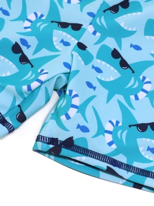 Detail of blue shark print on children's swimwear with durable flatlock stitching