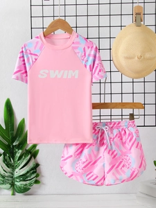Detail view of pink girls' two-piece swimwear with SWIM print and drawstring shorts