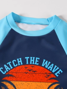 Close-up of boys' sun protection swimwear featuring sunset and palm tree print detail