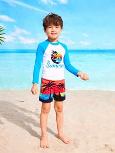 Close-up of boys long sleeve sun protection swimwear with sunset palm tree print