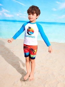 Detail of boys' long-sleeve sun protection swimwear set with tropical palm tree print