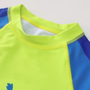 Kids long sleeve swimwear featuring neon green and blue stitching with coconut tree prints