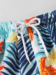 Macro view of elastic waistband with white drawstring on tropical print boys' swim shorts