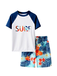 Detailed flat lay of boys' two-piece swimsuit with SURF print and tropical floral shorts