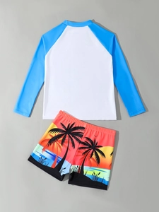 Detail of boys long sleeve sun protection swimwear with tropical coconut tree print
