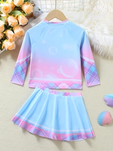 Flat lay of girl's blue-pink gradient long sleeve swimsuit with mermaid style skirt