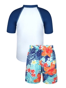 Detail view of boys' two-piece swimwear with raglan short sleeves and tropical print shorts