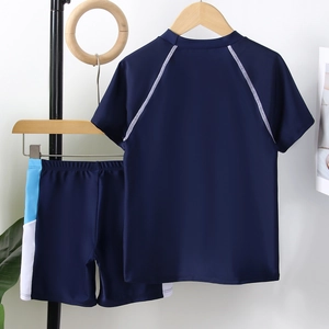 Boys two-piece swimsuit set with dark blue short sleeve top and athletic swim shorts