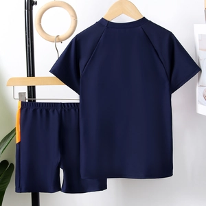 Two-piece boys' swimwear set with short sleeves and orange side panels in dark blue