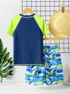 Detail view of boys' navy and neon short sleeve swimwear set with shark print swim shorts