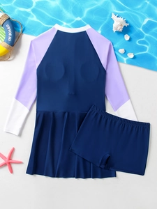 Detail of girls long sleeve sun protection swimwear set with skirt and shorts on beach props
