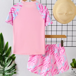 Girls two-piece pink sports swimsuit with floral short sleeves and matching printed shorts