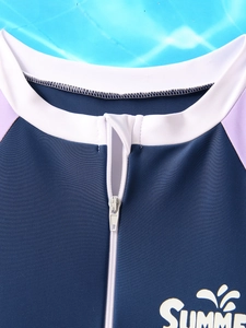 Detail of front zipper neckline and SUMMER print on girls long sleeve swimwear