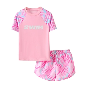 Pink two-piece girls swimsuit with short sleeves and floral print shorts