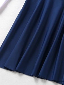 Macro shot of navy blue pleated fabric with fine twill texture on girl's swimwear