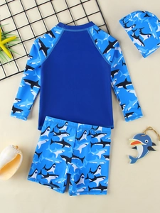 Three-piece boys' shark print swimwear with long sleeves, shorts, and matching swim cap