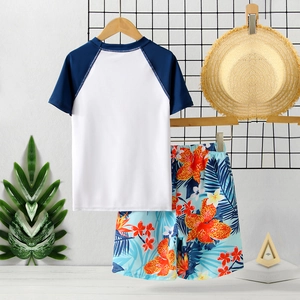 Boys two-piece swimwear set with short sleeve top and floral tropical beach shorts
