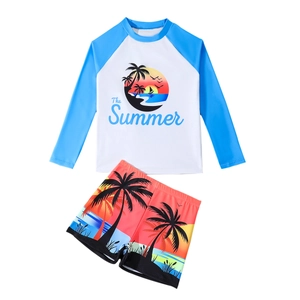 Kids long sleeve swimwear set featuring coconut tree print and blue raglan sun protection top