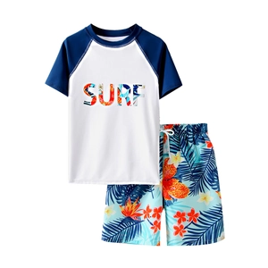 Two-piece boys swimming set with short sleeve surf top and tropical leaf print shorts