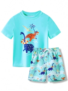Detail of boys' two-piece dinosaur swimsuit with short sleeve top and drawstring shorts