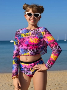 Detail of vibrant graffiti print on girls' long-sleeved two-piece sun protection swimsuit