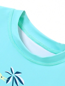 Detailed view of durable double-stitched neckline on blue dinosaur kids' swimwear