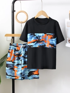Detail of boys camouflage swimwear set with short sleeve top and drawstring shorts
