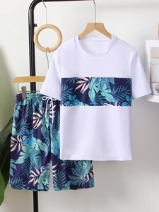 Detail of boys fast-dry swimwear featuring tropical palm leaf print on white T-shirt and shorts