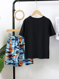 Detail of boys' camo swim shorts with elastic waistband and quick-dry fabric texture