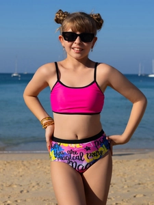 Detailed shot of girls' pink bikini top and colorful graffiti print high-waisted bottom