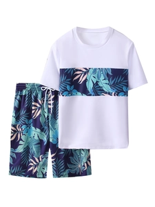 Detail of boys summer swimwear set featuring tropical palm leaf print and drawstring shorts