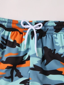 Detail of the elastic waistband with adjustable white drawstring on camo swim shorts